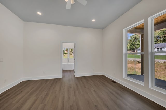 spare room featuring dark hardwood / wood-style flooring, a healthy amount of sunlight, and ceiling fan