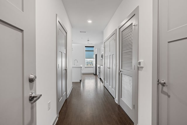 corridor featuring dark hardwood / wood-style flooring