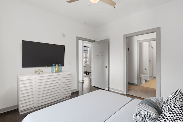 bedroom with ceiling fan, dark hardwood / wood-style floors, and ensuite bath