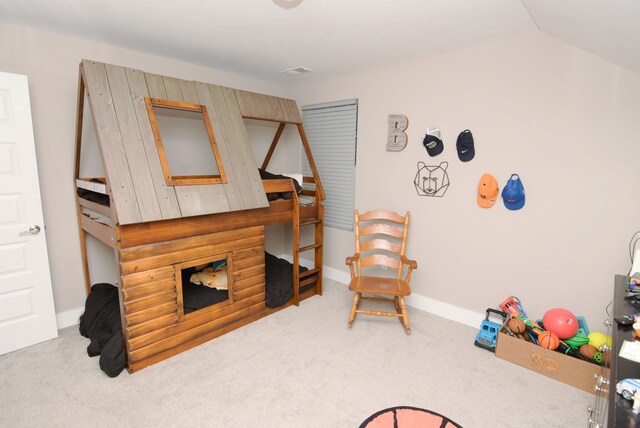 recreation room featuring light colored carpet and vaulted ceiling