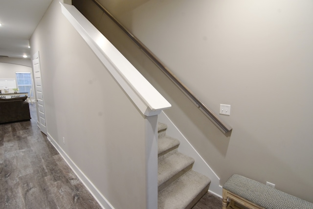 stairs featuring wood-type flooring