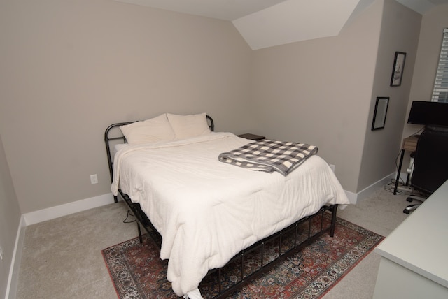 bedroom with carpet flooring and vaulted ceiling