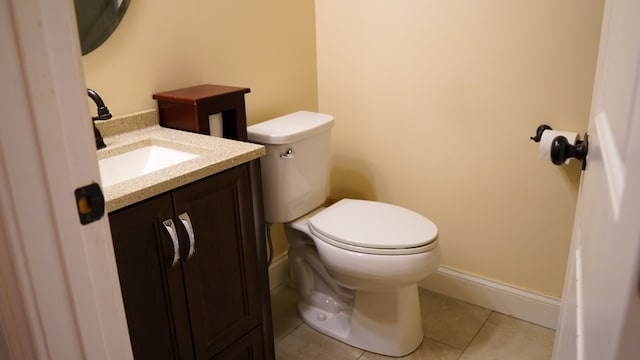 bathroom featuring vanity, toilet, and tile patterned flooring