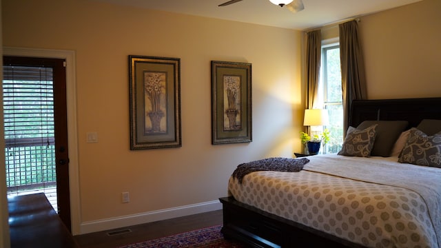 bedroom with ceiling fan and dark wood-type flooring