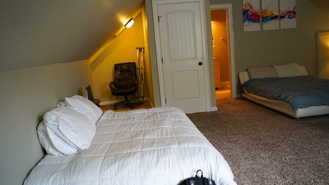 carpeted bedroom with vaulted ceiling