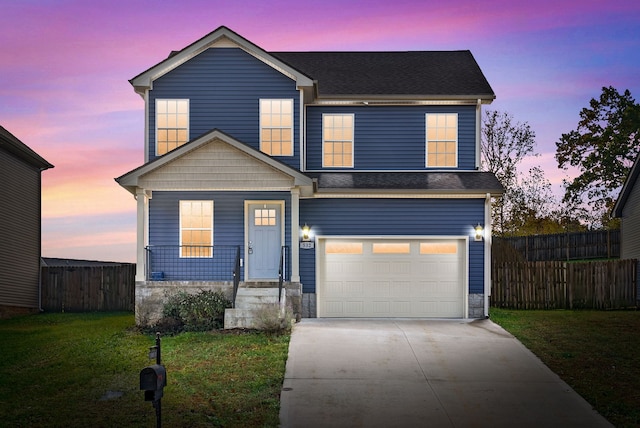 view of front of home featuring a lawn and a garage