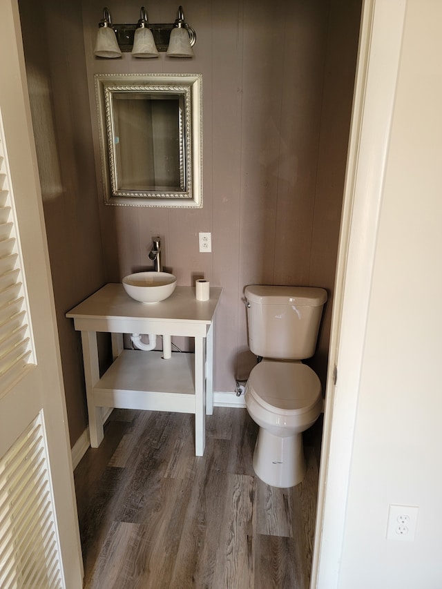 bathroom with hardwood / wood-style floors, sink, and toilet