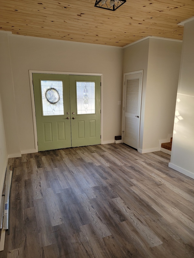 entrance foyer featuring hardwood / wood-style flooring, wood ceiling, french doors, and ornamental molding