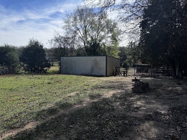 view of yard with an outdoor structure and a rural view