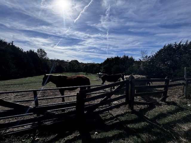 view of gate with a rural view