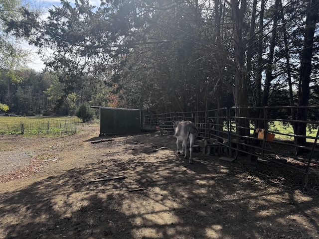 view of yard with an outbuilding and a rural view