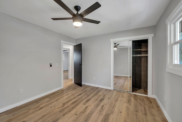 unfurnished bedroom featuring a closet, ceiling fan, and light hardwood / wood-style flooring