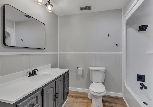 bathroom with wood-type flooring, vanity, and toilet