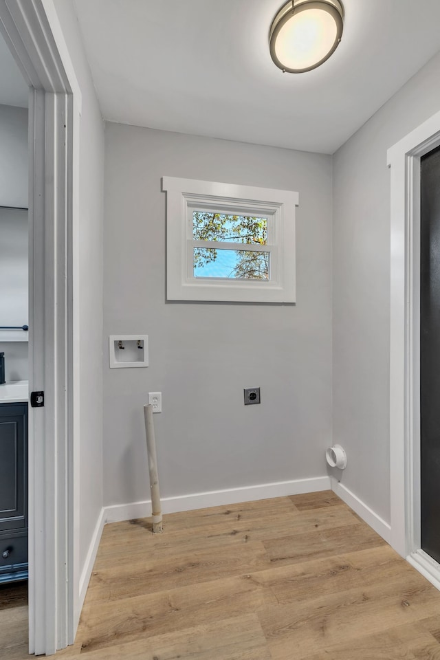 washroom with washer hookup, light hardwood / wood-style floors, and electric dryer hookup