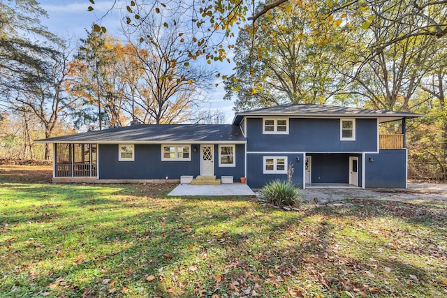 view of front of house with a sunroom and a front yard