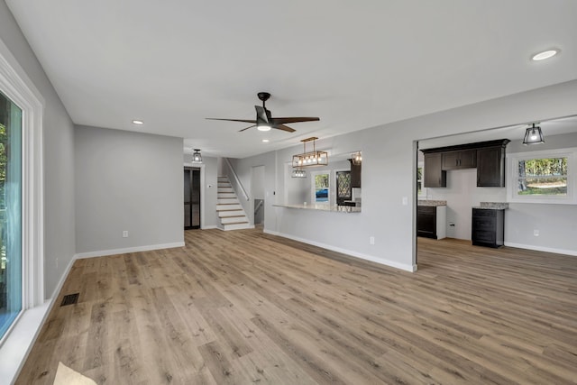 unfurnished living room featuring ceiling fan and light hardwood / wood-style flooring