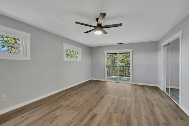 empty room with light hardwood / wood-style flooring and ceiling fan