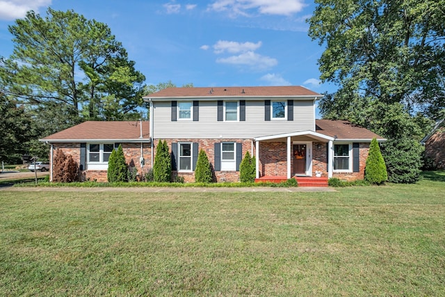 colonial inspired home with a front lawn