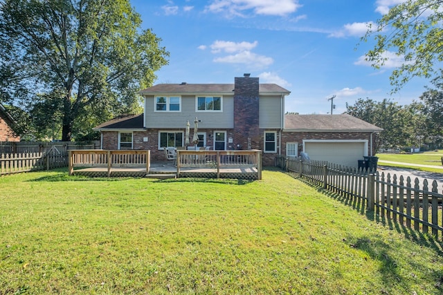 rear view of house featuring a wooden deck, a garage, and a yard