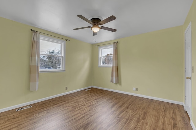 unfurnished room featuring hardwood / wood-style flooring and ceiling fan