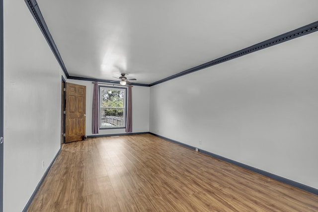 empty room featuring crown molding, ceiling fan, and hardwood / wood-style flooring