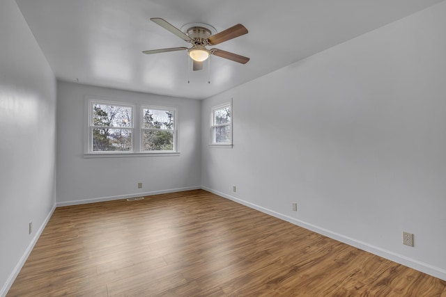 empty room with hardwood / wood-style flooring and ceiling fan