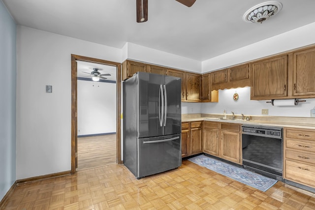 kitchen with sink, stainless steel refrigerator, dishwasher, ceiling fan, and light parquet flooring