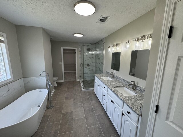 1805 Pointe Ct, Lebanon, TN 37087 - full bathroom with a stall shower, a freestanding bath, double vanity, a textured ceiling, and toilet