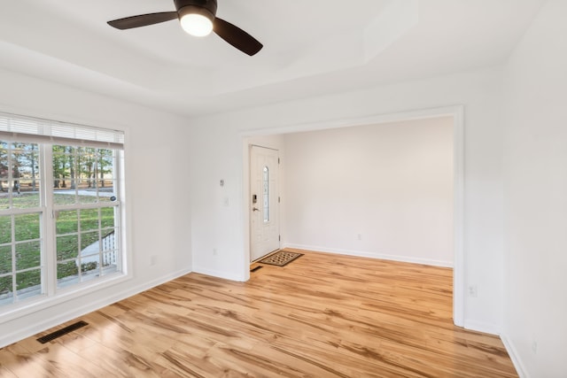 empty room with light hardwood / wood-style flooring and ceiling fan