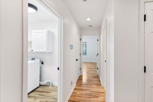 hallway featuring light wood-type flooring and washer / dryer