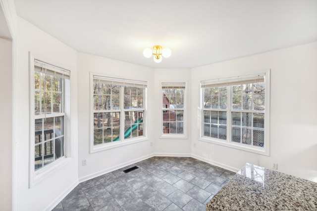 unfurnished dining area featuring an inviting chandelier