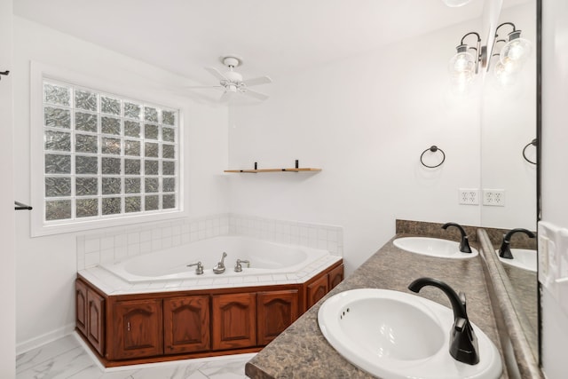 bathroom with vanity, ceiling fan, and a bathing tub