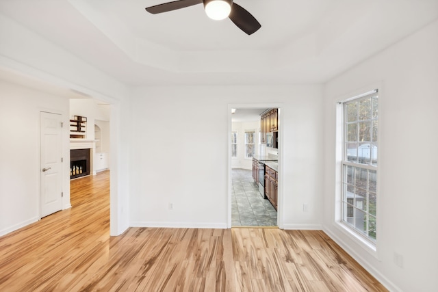 unfurnished room featuring light hardwood / wood-style flooring and ceiling fan