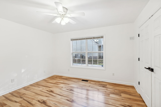 unfurnished room with ceiling fan and light hardwood / wood-style flooring