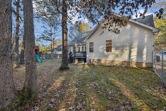 view of home's exterior featuring a playground and a lawn