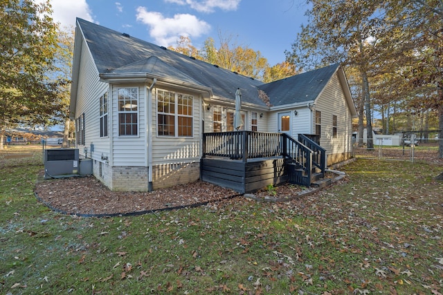 exterior space featuring a lawn and a wooden deck