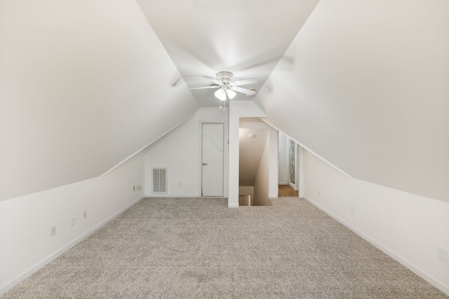 bonus room with ceiling fan, light colored carpet, and vaulted ceiling