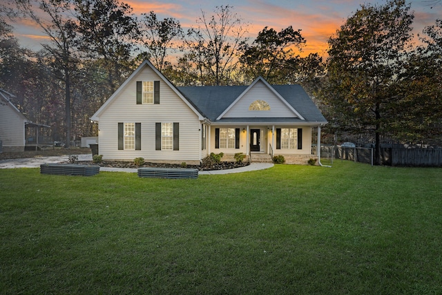 view of front of property with a lawn and a porch