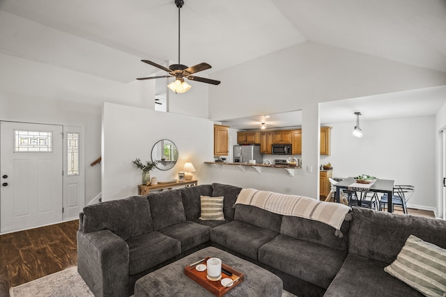 living room featuring dark hardwood / wood-style flooring, high vaulted ceiling, and ceiling fan