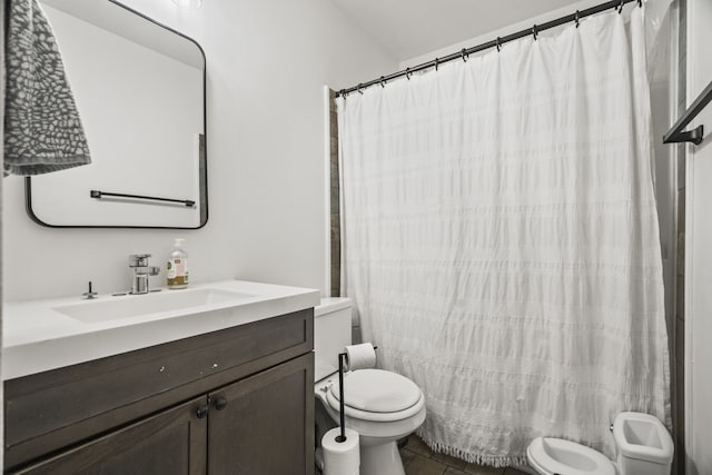 bathroom featuring vanity, curtained shower, tile patterned flooring, and toilet