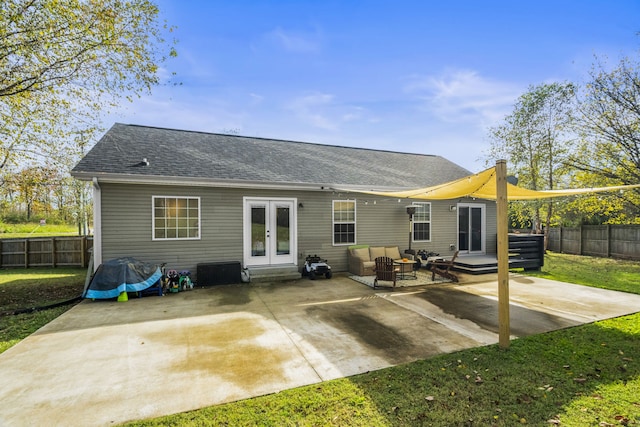 rear view of property featuring french doors, outdoor lounge area, a lawn, and a patio area