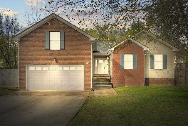 view of front of house featuring a garage and a yard