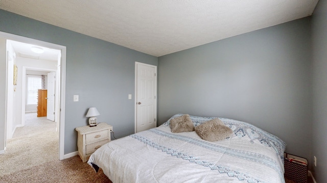 carpeted bedroom with a textured ceiling