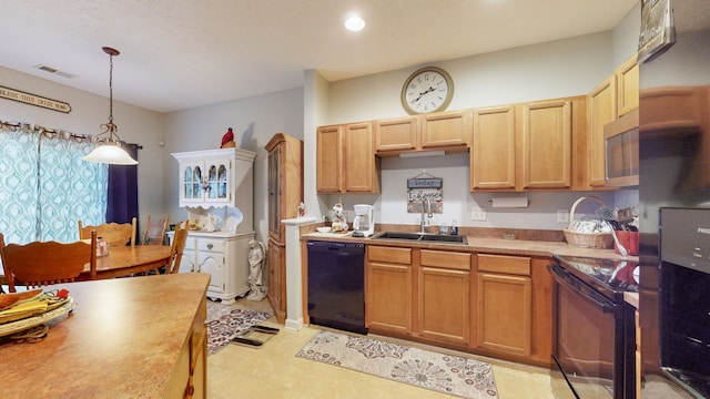 kitchen with pendant lighting, sink, and black appliances