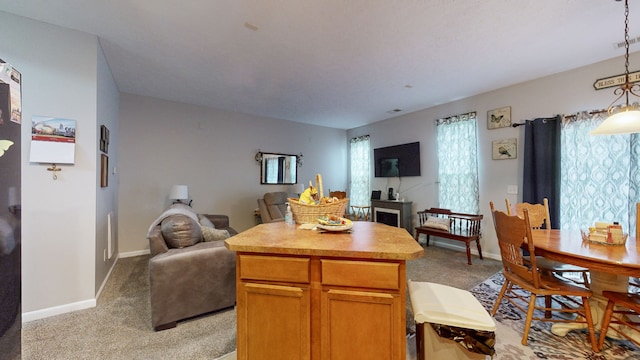 dining area featuring light carpet