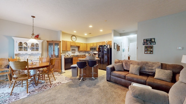 carpeted living room featuring a textured ceiling