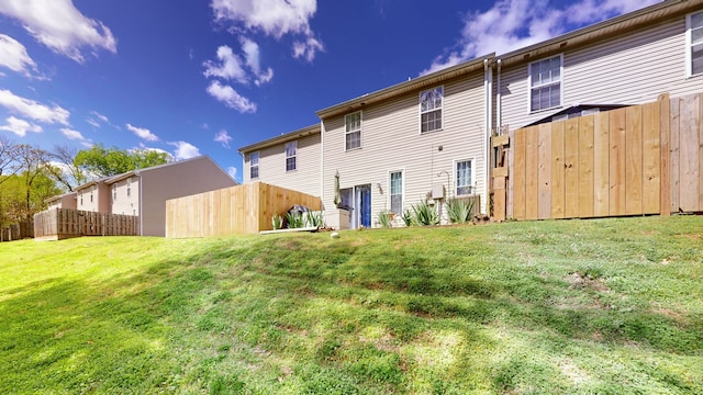 rear view of house featuring a yard