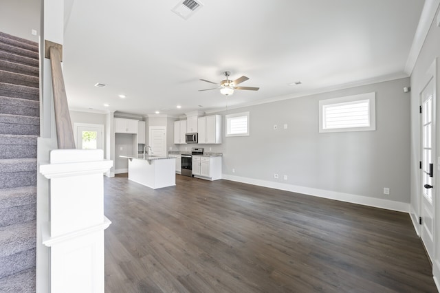 unfurnished living room featuring ceiling fan, crown molding, sink, and dark hardwood / wood-style flooring