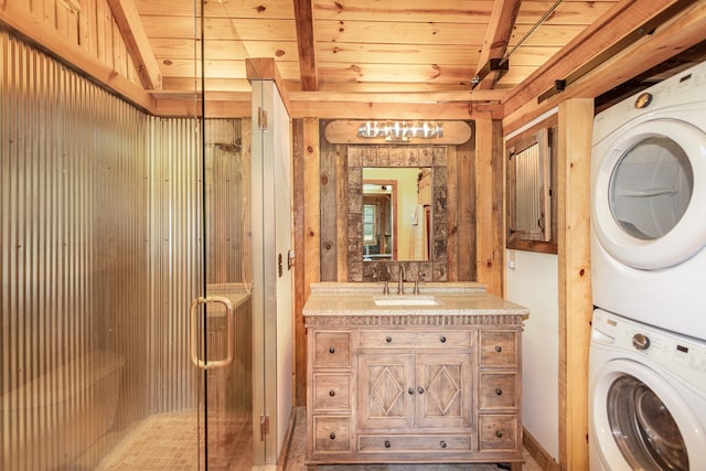 interior space with stacked washer and dryer, vanity, wood ceiling, and walk in shower