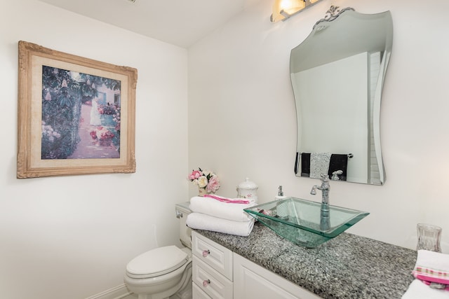 bathroom with toilet and vanity